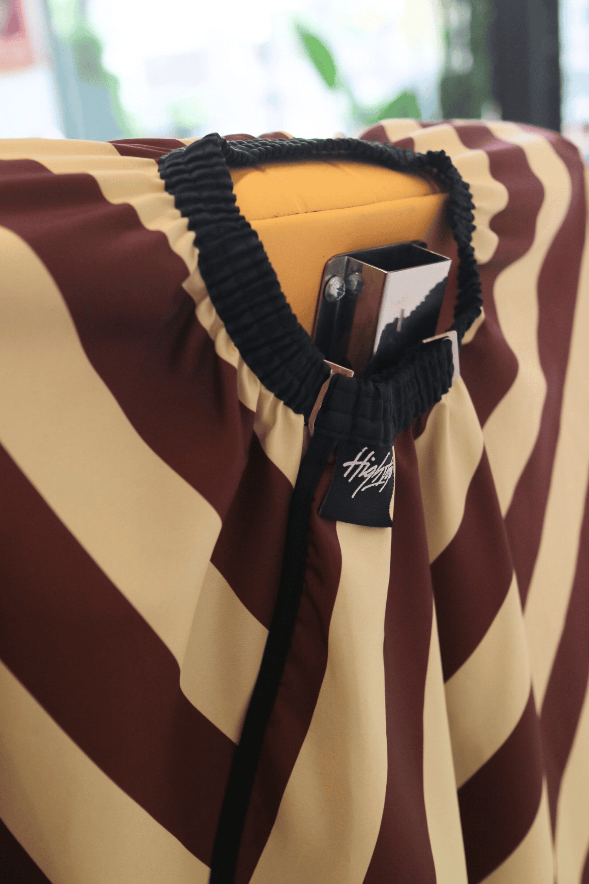 photo of elastic neck on burgundy banded barber cape