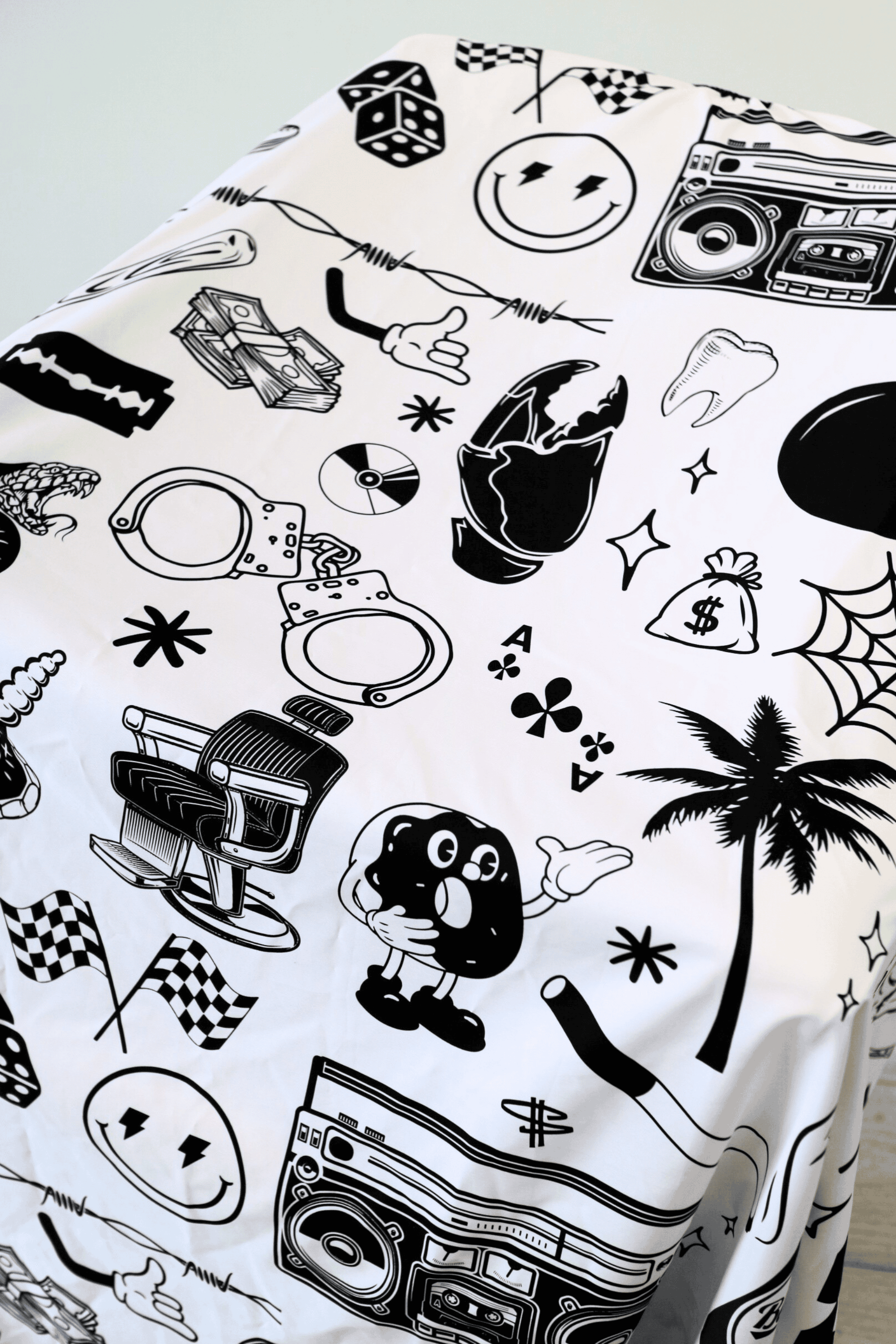 close up of tattoo flash barber cape