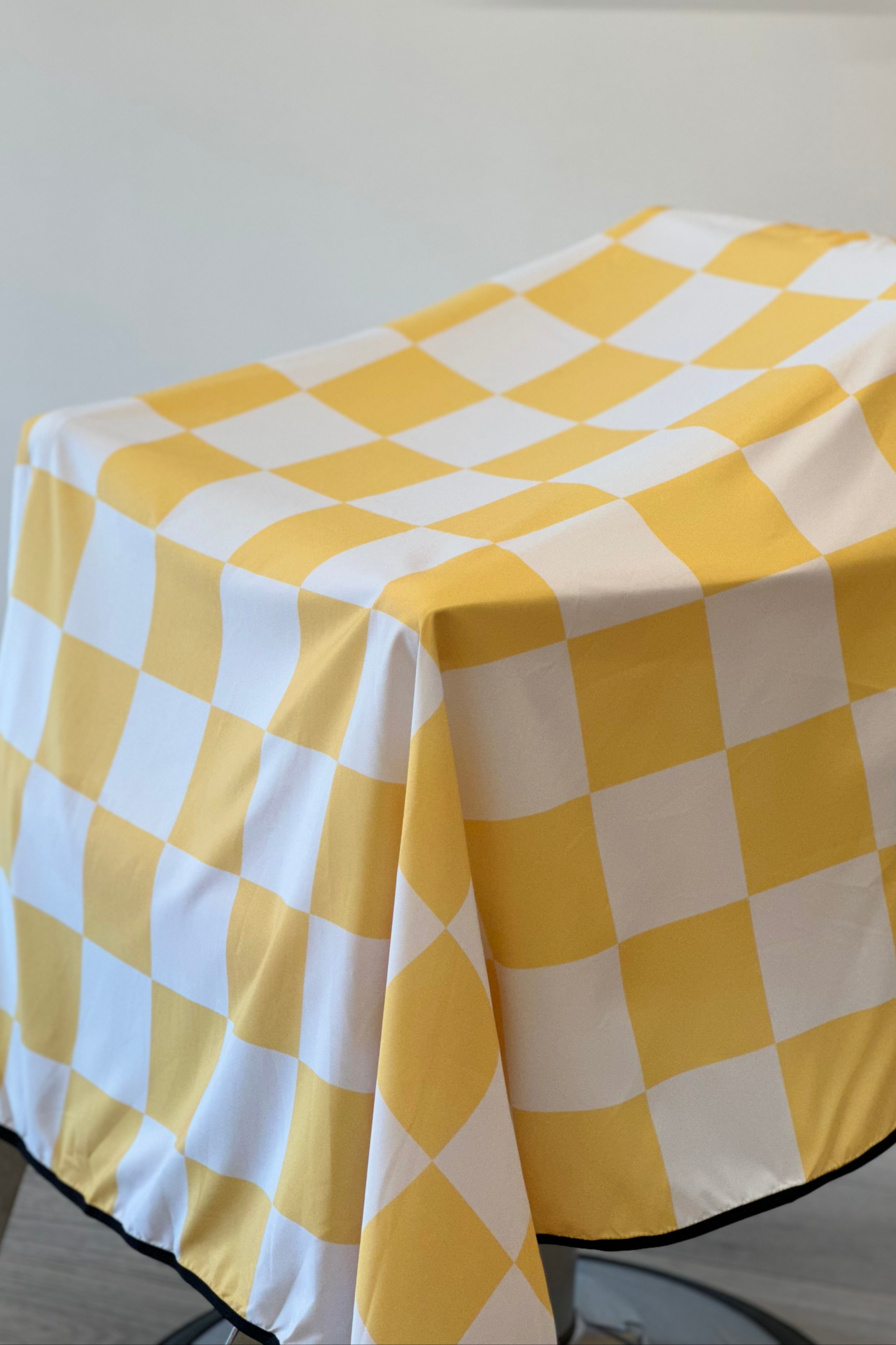 a close up shot of the yellow rally v2 checker barber cutting cape