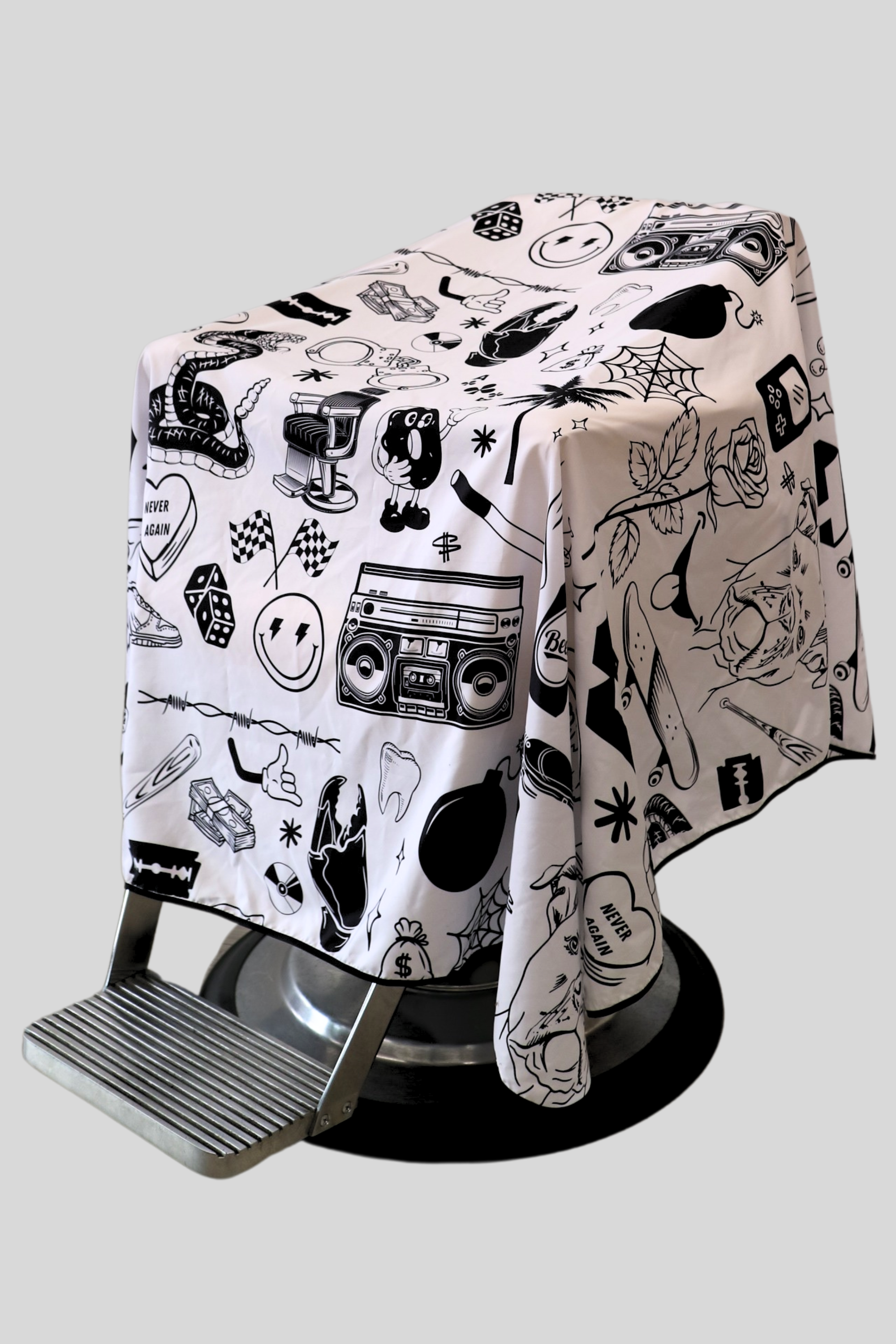 Tattoo flash barber cutting cape in black and white draped on barber chair