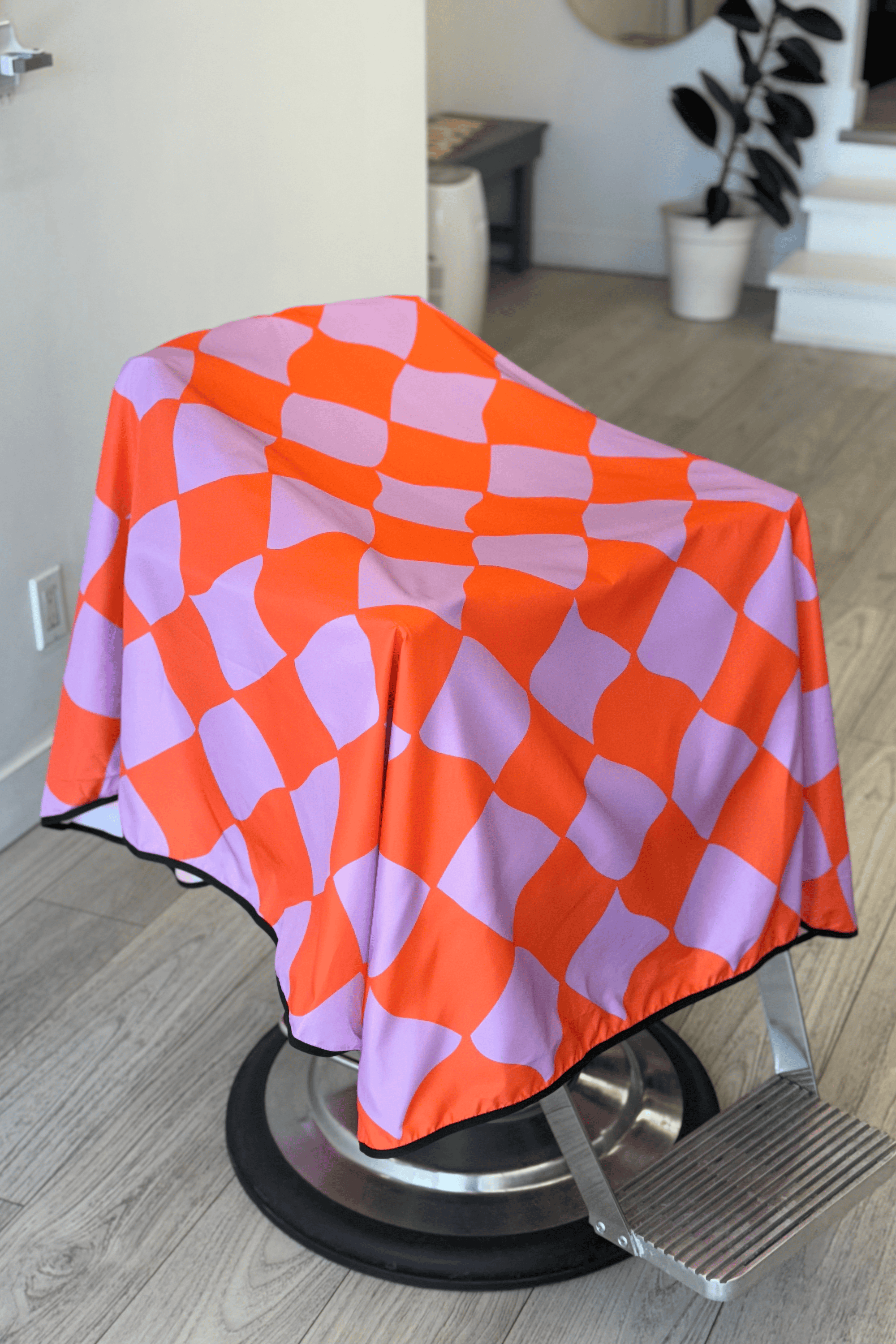 kids funhouse barber cape draped on barbershop chair