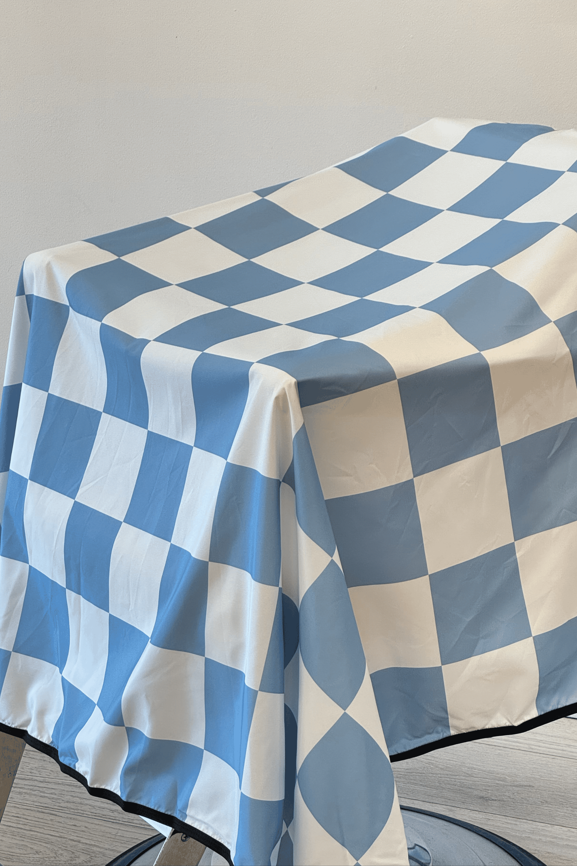 a close up shot of the rally v2 blue checker barber cape