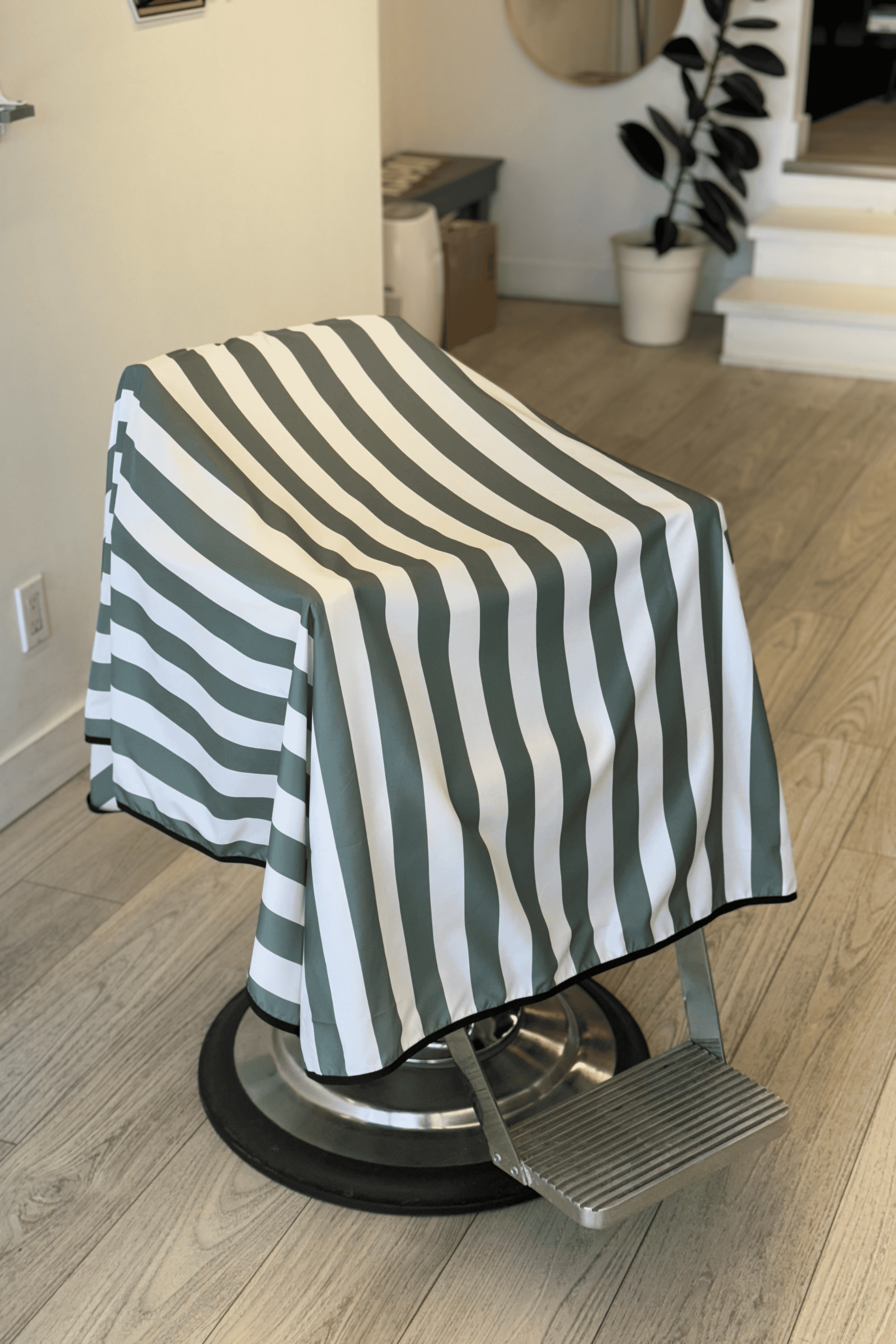 striped green and white barber cape in barbershop