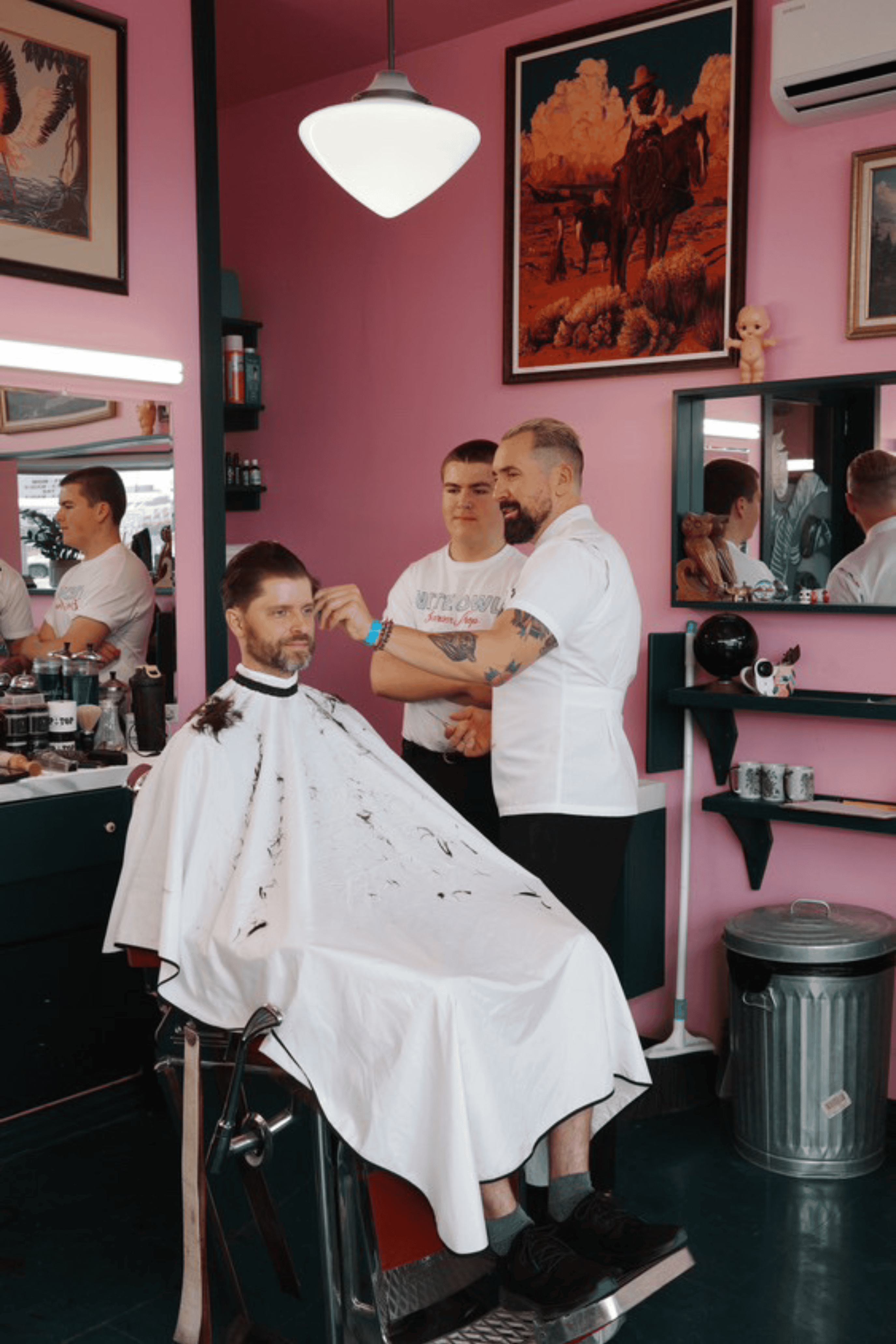 white classic barber cutting cape inside Nite Owl Barbershop 